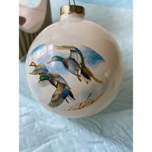 vintage glass ball ornament featuring hand-painted mallard ducks in flight